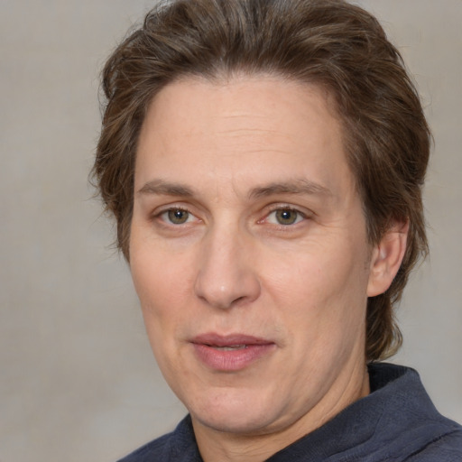 Joyful white adult male with medium  brown hair and brown eyes