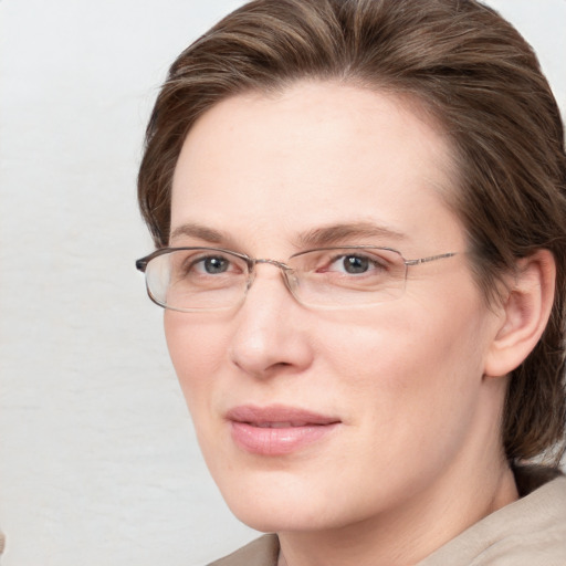 Joyful white adult female with medium  brown hair and blue eyes