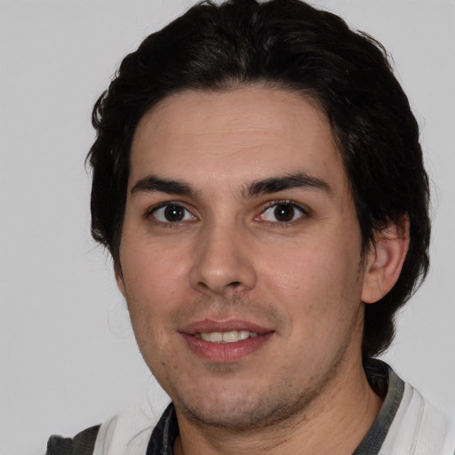 Joyful white young-adult male with short  black hair and brown eyes