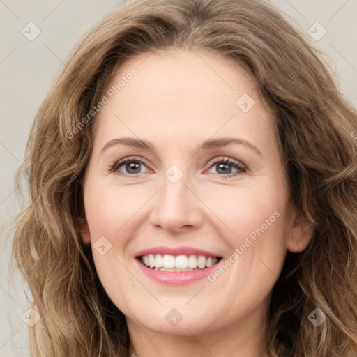 Joyful white young-adult female with long  brown hair and green eyes