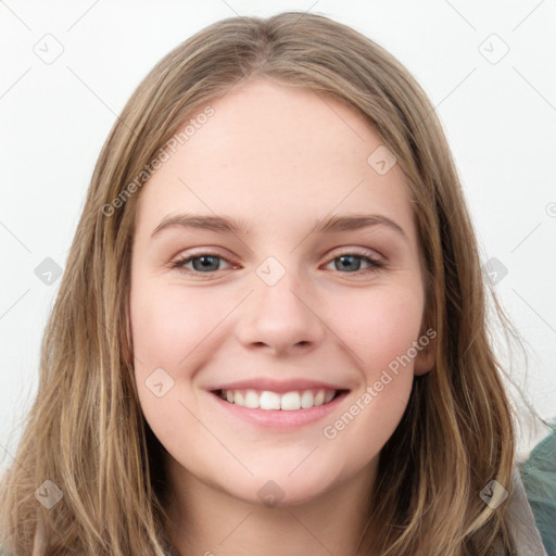 Joyful white young-adult female with long  brown hair and blue eyes