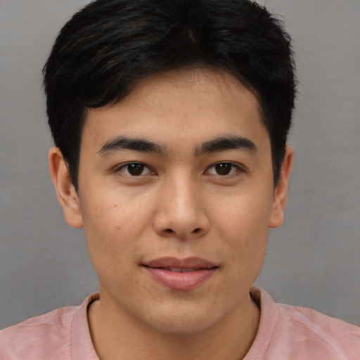 Joyful asian young-adult male with short  brown hair and brown eyes
