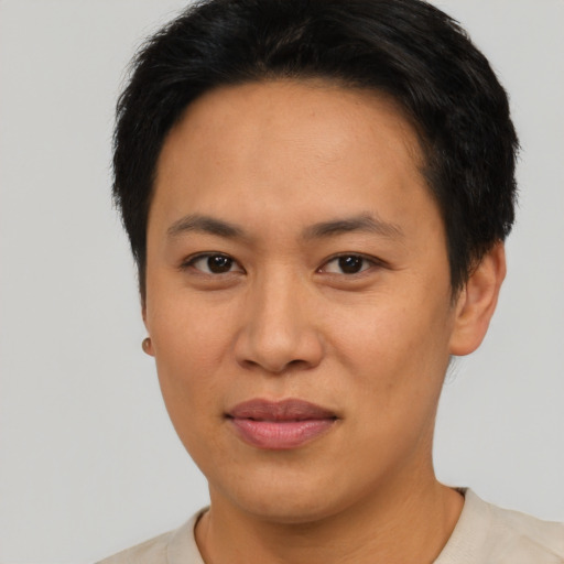 Joyful asian adult female with short  brown hair and brown eyes