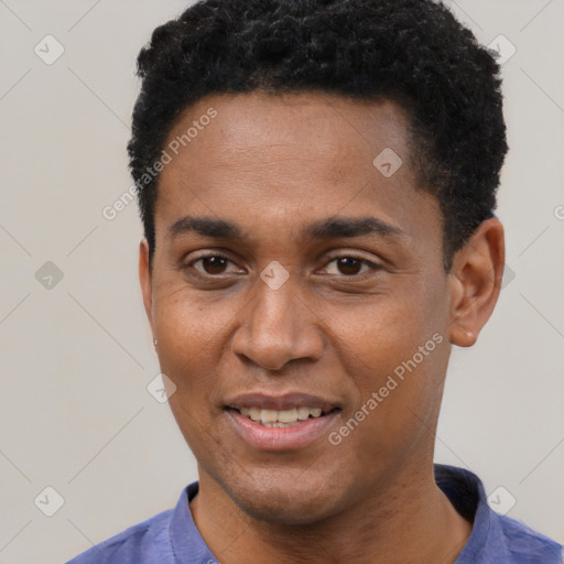 Joyful black young-adult male with short  black hair and brown eyes