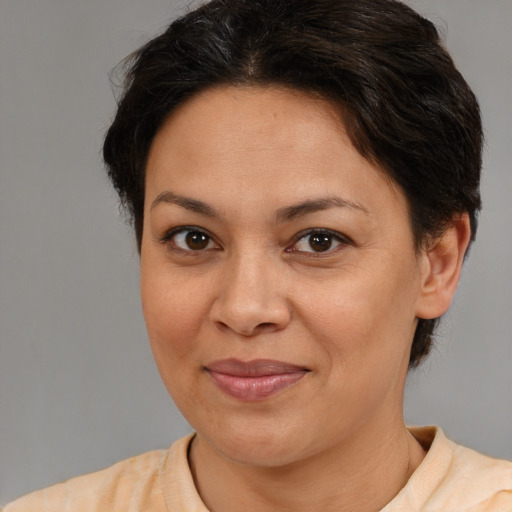 Joyful white adult female with medium  brown hair and brown eyes