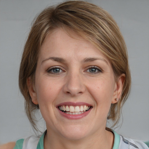 Joyful white young-adult female with medium  brown hair and blue eyes