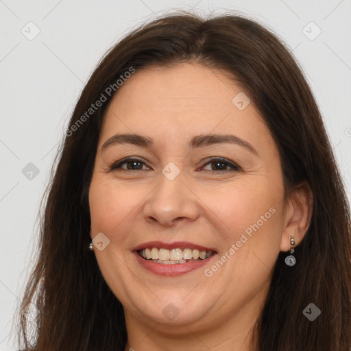 Joyful white adult female with long  brown hair and brown eyes