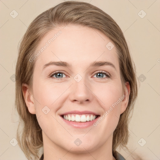 Joyful white young-adult female with medium  brown hair and green eyes