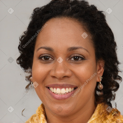 Joyful black adult female with long  brown hair and brown eyes