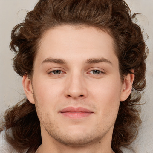 Joyful white young-adult male with medium  brown hair and brown eyes