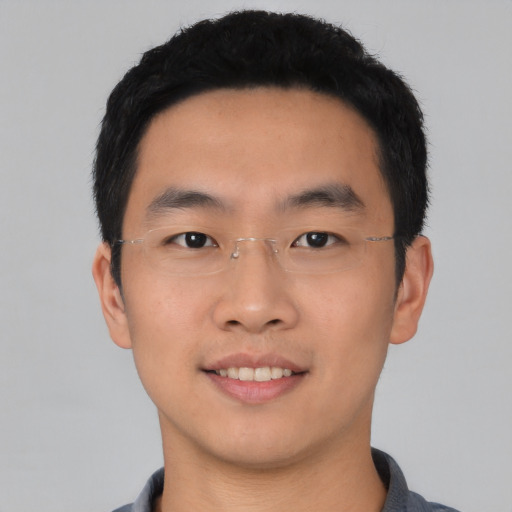 Joyful asian young-adult male with short  black hair and brown eyes