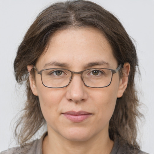 Joyful white adult female with medium  brown hair and grey eyes