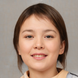 Joyful white child female with medium  brown hair and brown eyes