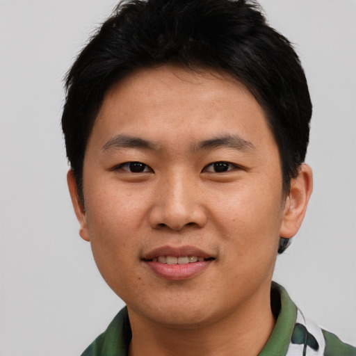 Joyful asian young-adult male with short  black hair and brown eyes