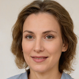 Joyful white young-adult female with medium  brown hair and green eyes