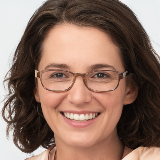 Joyful white adult female with long  brown hair and grey eyes