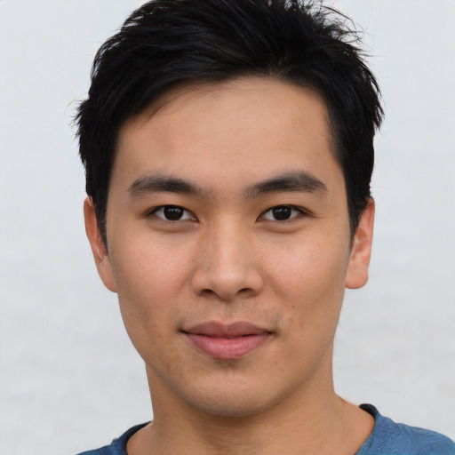 Joyful asian young-adult male with short  black hair and brown eyes