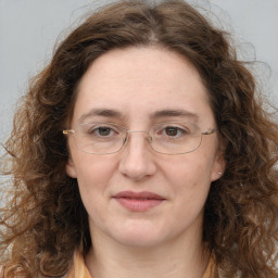 Joyful white adult female with long  brown hair and brown eyes