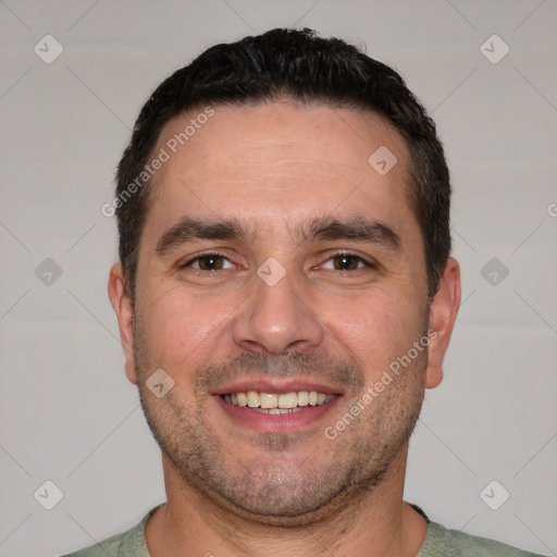 Joyful white adult male with short  black hair and brown eyes