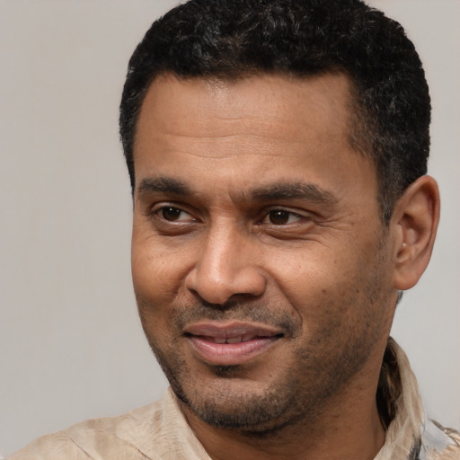 Joyful latino adult male with short  black hair and brown eyes