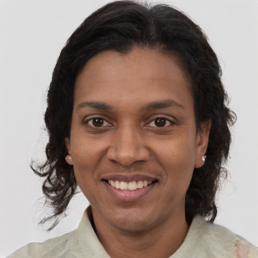 Joyful black young-adult female with medium  brown hair and brown eyes