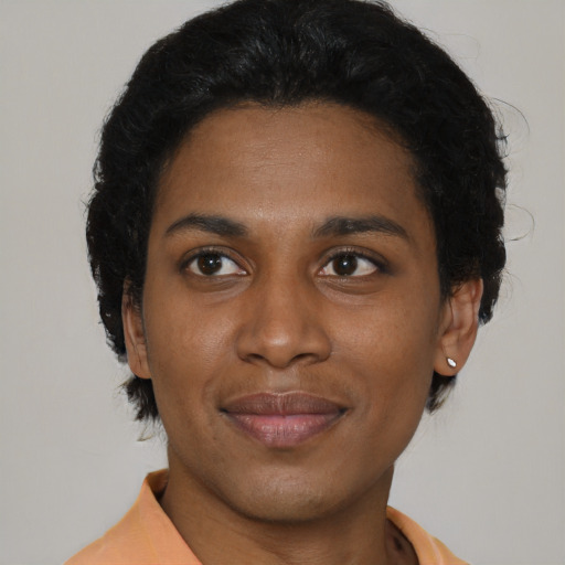 Joyful black young-adult female with short  brown hair and brown eyes