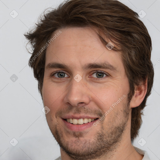 Joyful white adult male with short  brown hair and brown eyes