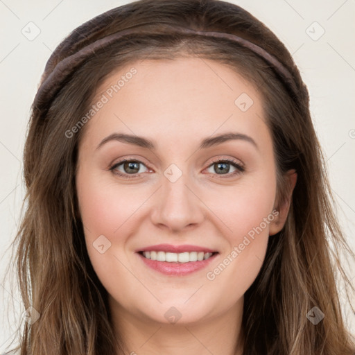 Joyful white young-adult female with long  brown hair and blue eyes