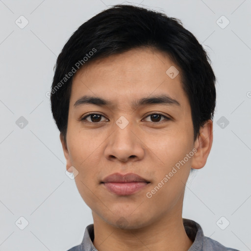 Joyful asian young-adult male with short  black hair and brown eyes