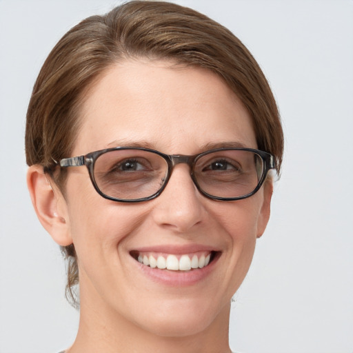 Joyful white young-adult female with short  brown hair and blue eyes