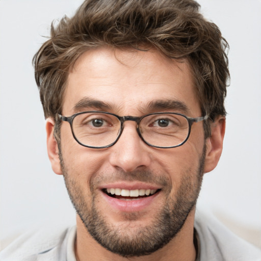 Joyful white adult male with short  brown hair and grey eyes