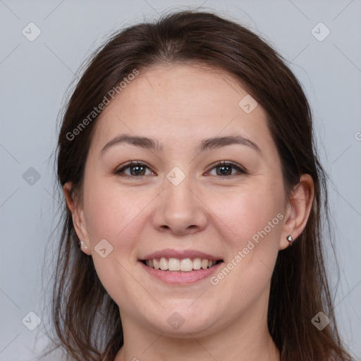 Joyful white young-adult female with long  brown hair and brown eyes