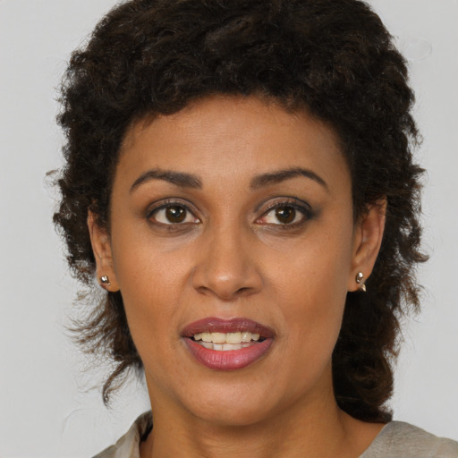 Joyful black young-adult female with medium  brown hair and brown eyes