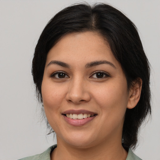 Joyful white young-adult female with medium  black hair and brown eyes