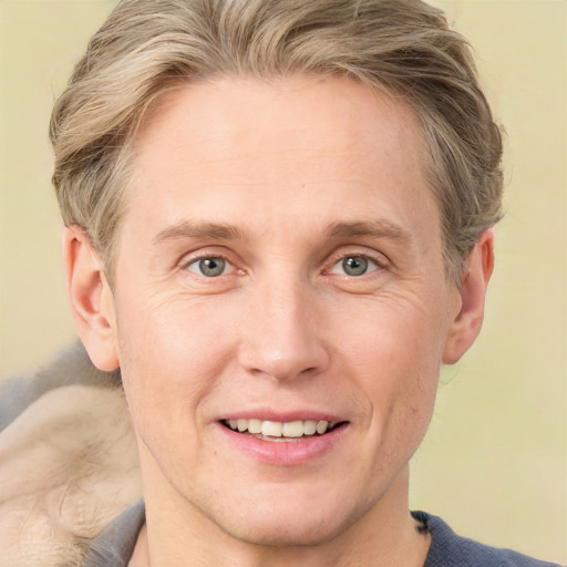 Joyful white adult male with medium  brown hair and grey eyes