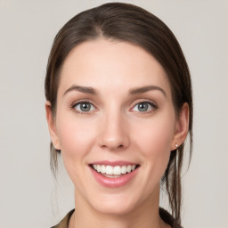 Joyful white young-adult female with medium  brown hair and grey eyes