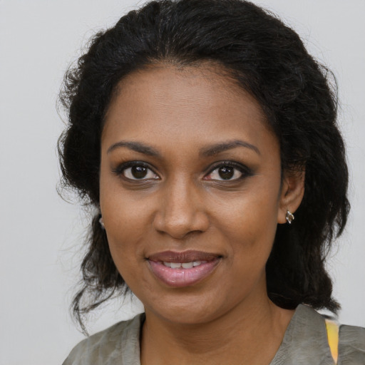Joyful black young-adult female with medium  brown hair and brown eyes