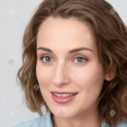 Joyful white young-adult female with medium  brown hair and blue eyes