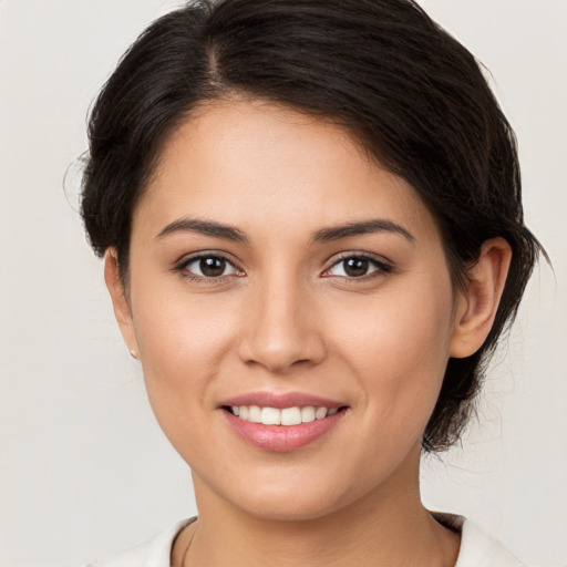 Joyful white young-adult female with medium  brown hair and brown eyes