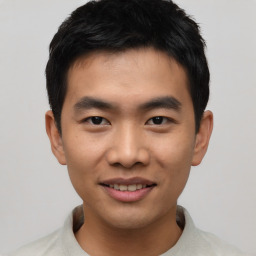 Joyful asian young-adult male with short  black hair and brown eyes