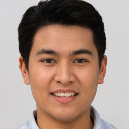 Joyful asian young-adult male with short  black hair and brown eyes