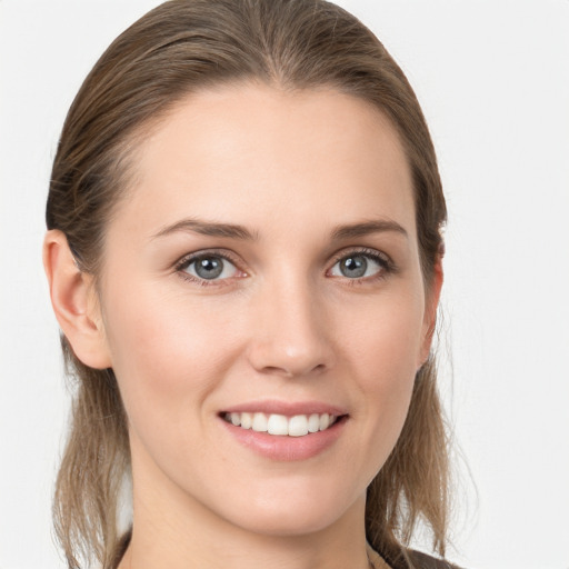 Joyful white young-adult female with medium  brown hair and grey eyes