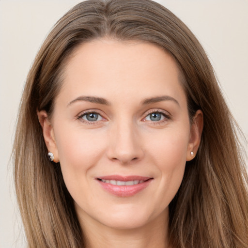 Joyful white young-adult female with long  brown hair and grey eyes