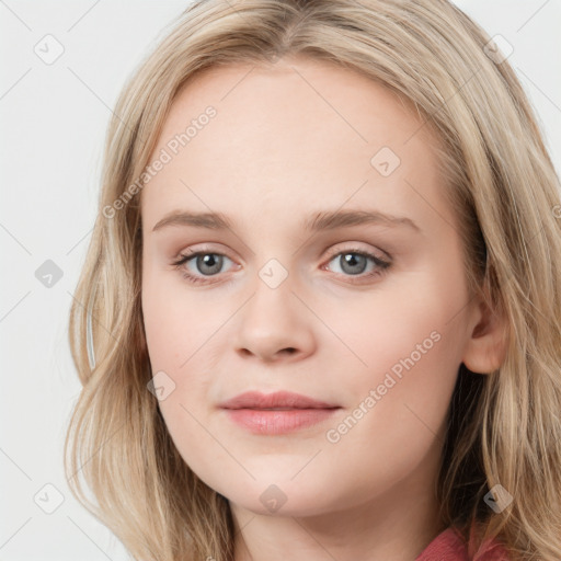 Joyful white young-adult female with long  brown hair and blue eyes