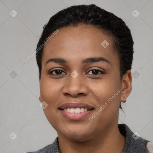 Joyful black young-adult female with short  black hair and brown eyes