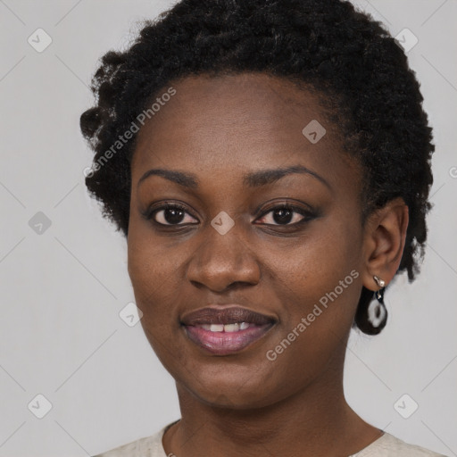 Joyful black young-adult female with short  black hair and brown eyes