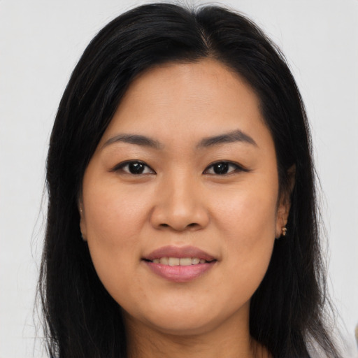 Joyful asian young-adult female with long  brown hair and brown eyes