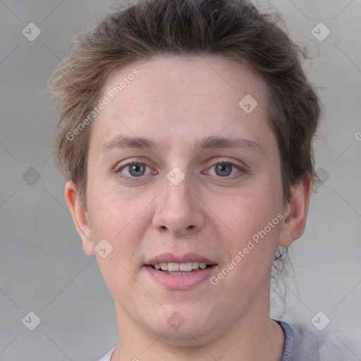 Joyful white adult female with short  brown hair and grey eyes