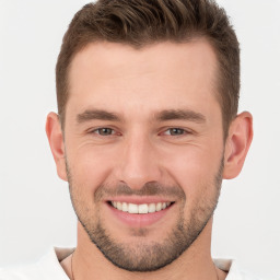 Joyful white young-adult male with short  brown hair and brown eyes