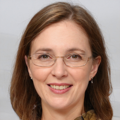 Joyful white adult female with medium  brown hair and blue eyes